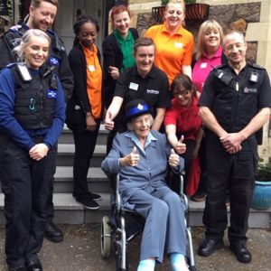 Anne pictured outside her care home with police officers