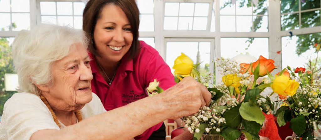 Resident and Care assistant flower arranging