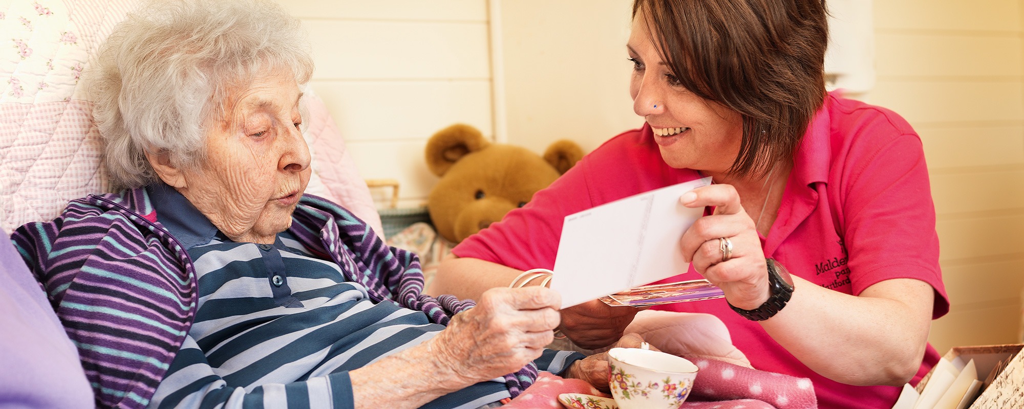Carer talks with resident about postcard dementia