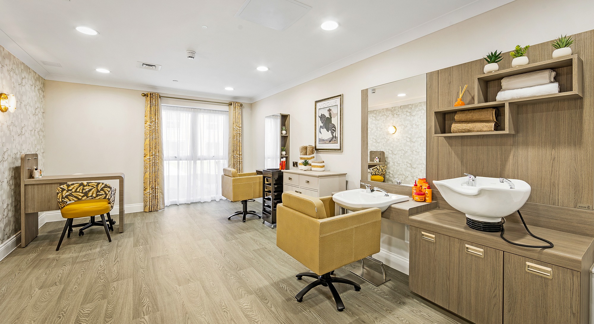 Two comfortable salon chairs facing hair wash stations at Moorhill’s hair and beauty salon, with a nail bar visible in the left corner