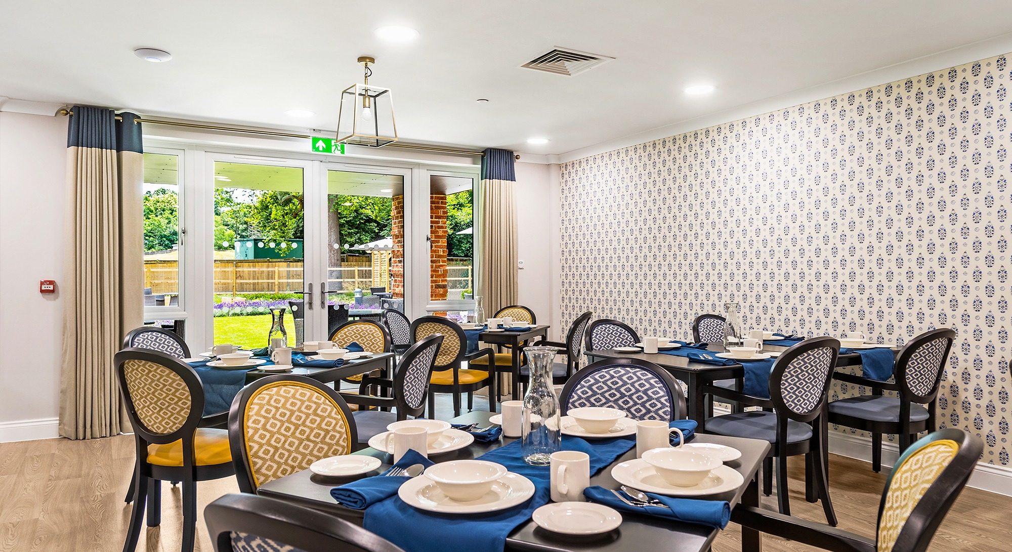Dining room at Moorhill Care Home set with tables ready for residents, shown from an alternate angle