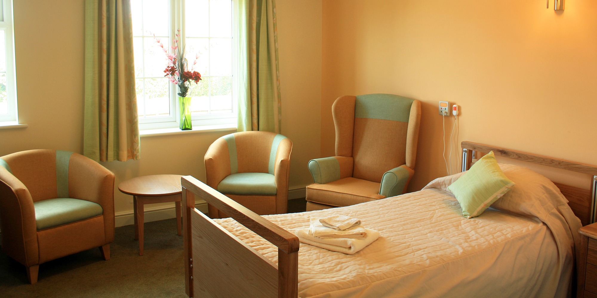 A bedroom at Woodchurch House Care Home