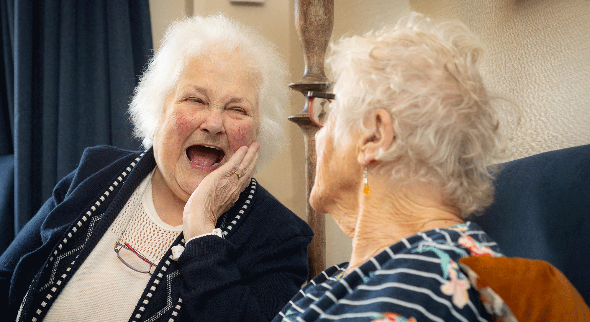 Joyful moment shared between two elderly ladies