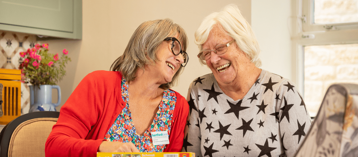 Resident and Carer having a conversation together at Woodchurch House Care Home in Woodchurch, Ashford