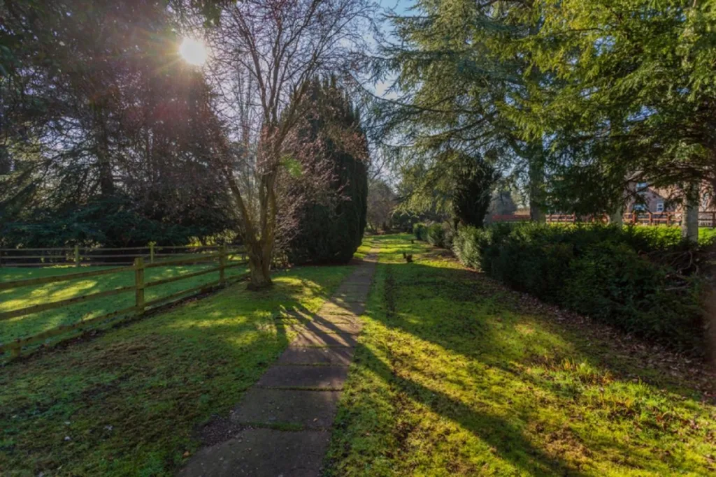 Well-maintained garden at Ashgrove Care Home in Wrexham with pathways and seating areas