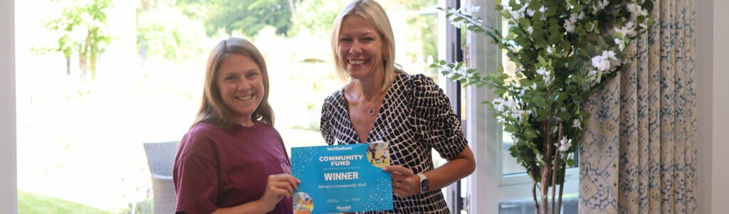 Hartford Care director presenting £1,000 community grant cheque to Monty's Community Hub representatives in Southampton