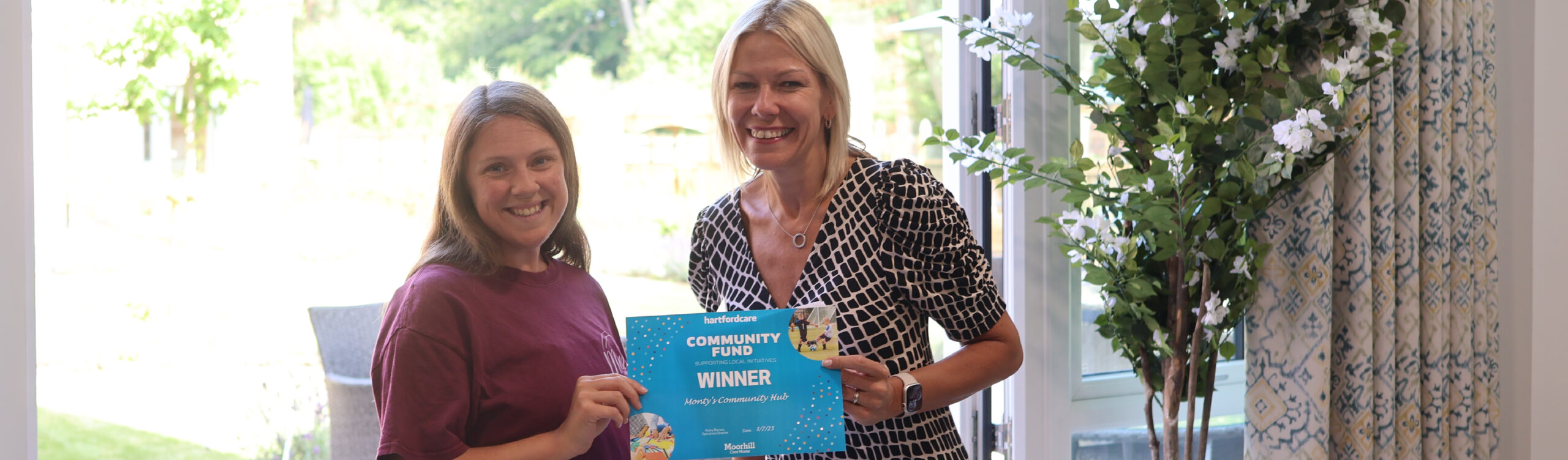 Hartford Care director presenting £1,000 community grant cheque to Monty's Community Hub representatives in Southampton